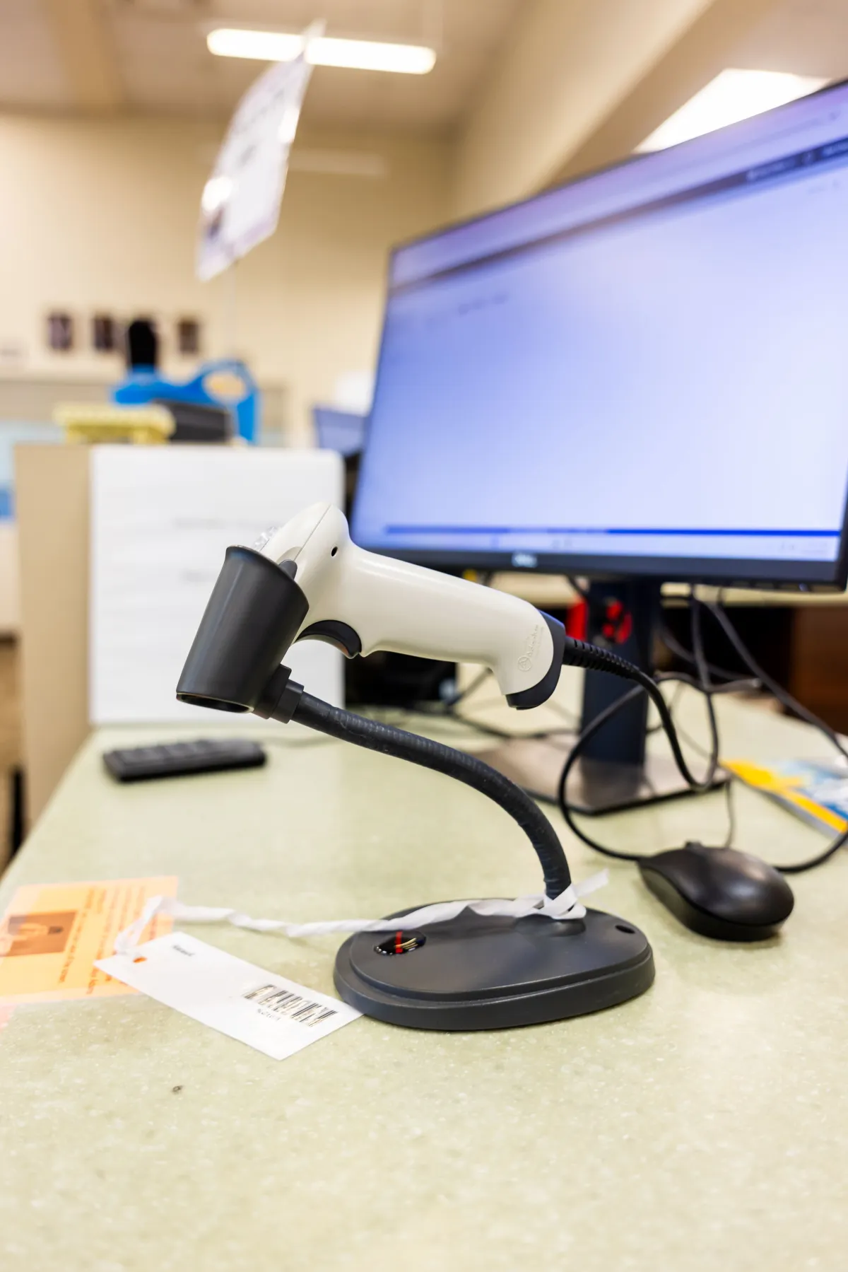 Câmera de segurança PoE em uma bancada de escritório com monitor ao fundo, cabos conectados e equipamento de teste para instalação e configuração