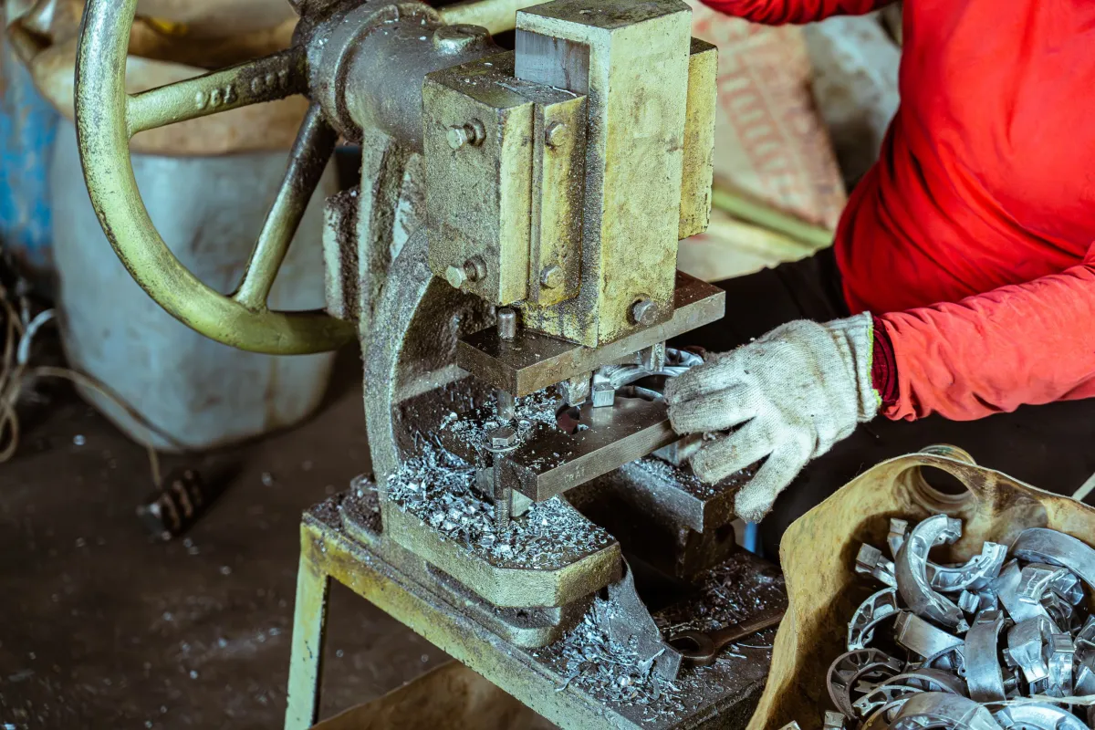Trabalhador utilizando equipamento para processamento de metal.